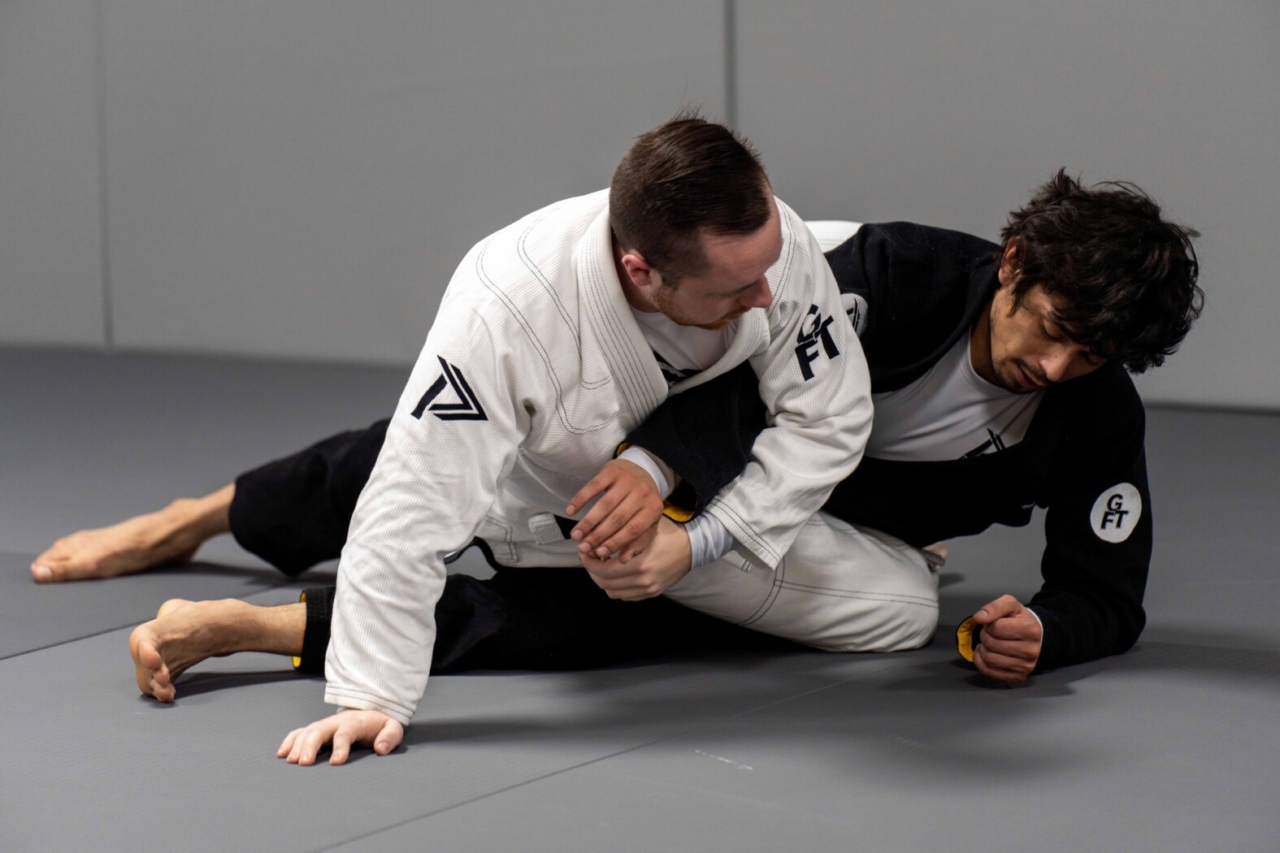 Technique demonstration between two men during a training class