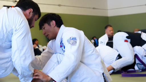 BJJ students sparring in a Brazilian jiu-jitsu class at our Richardson, TX martial arts academy.